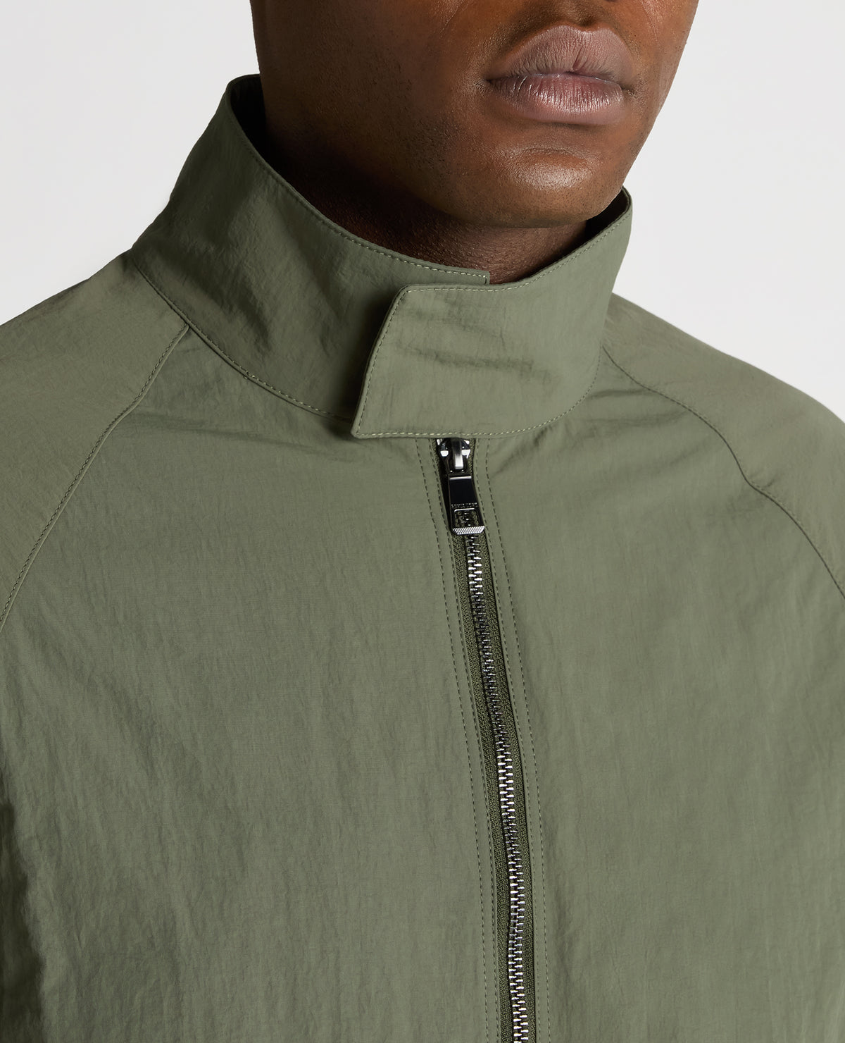Man wearing a green Regular Fit Showerproof Harrington Jacket