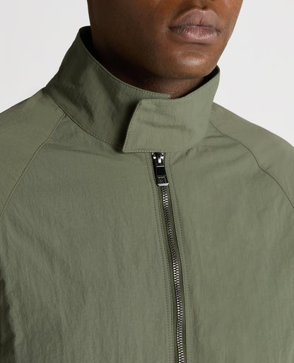 Man wearing a green Regular Fit Showerproof Harrington Jacket