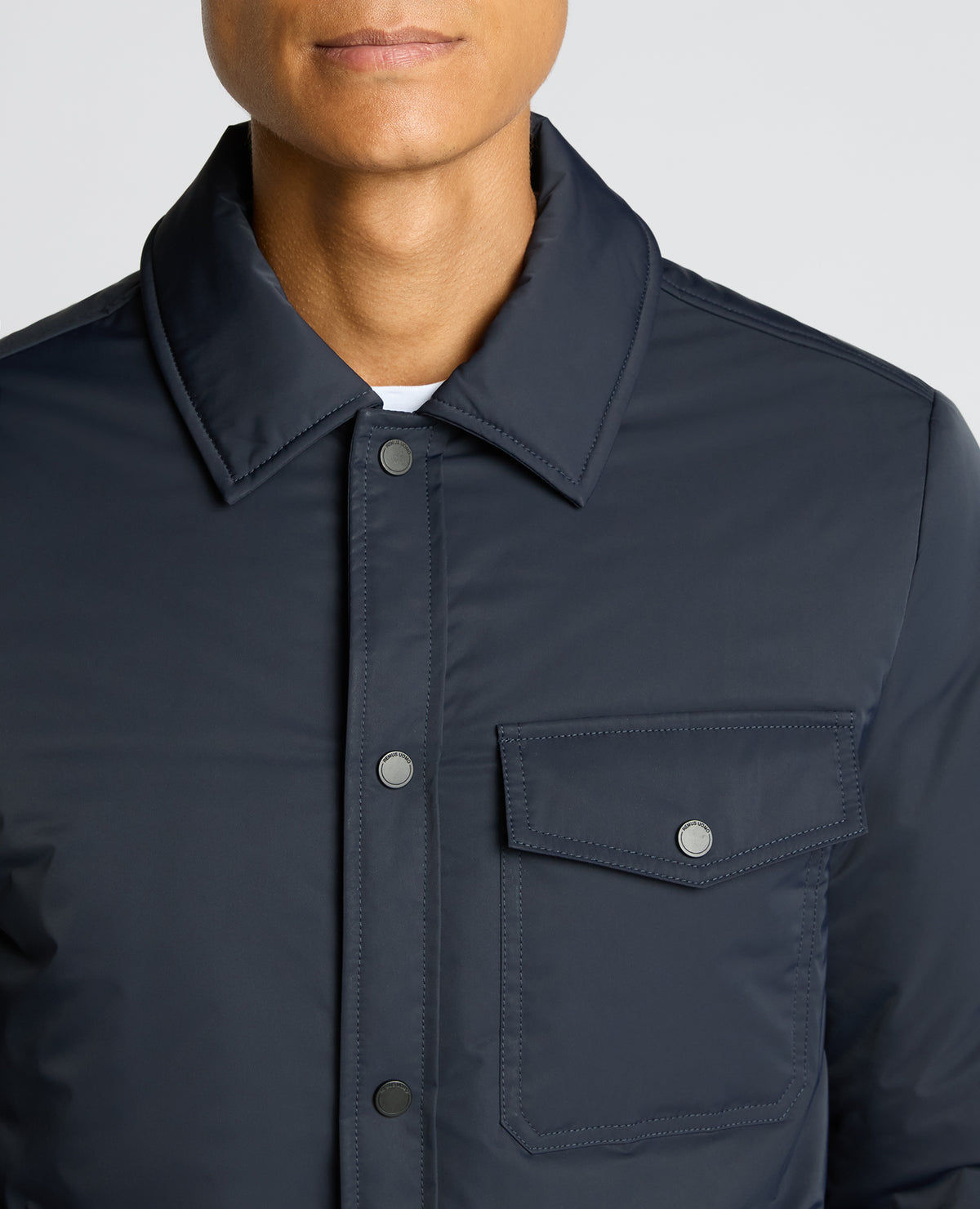 Man wearing a navy Padded Button-Up Jacket
