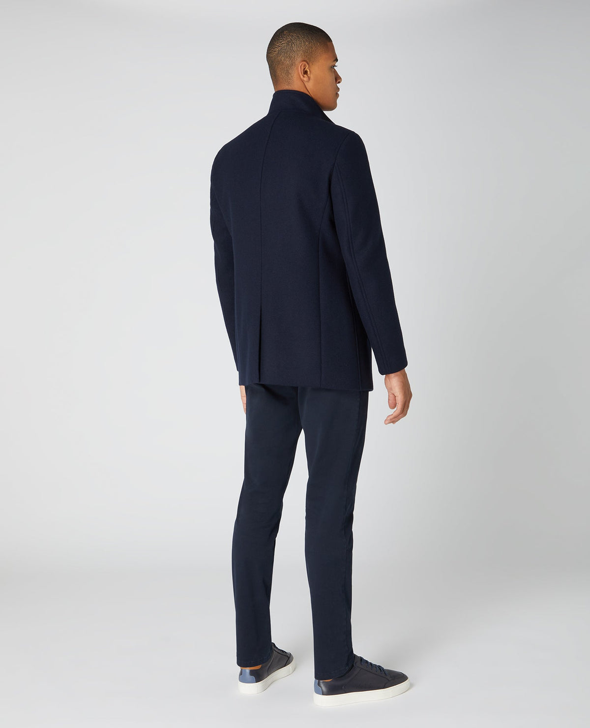 Man wearing a navy Tapered Fit Wool-Blend Tailored Coat