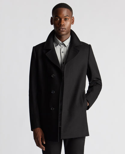 Man wearing a black Tailored Fit Overcoat
