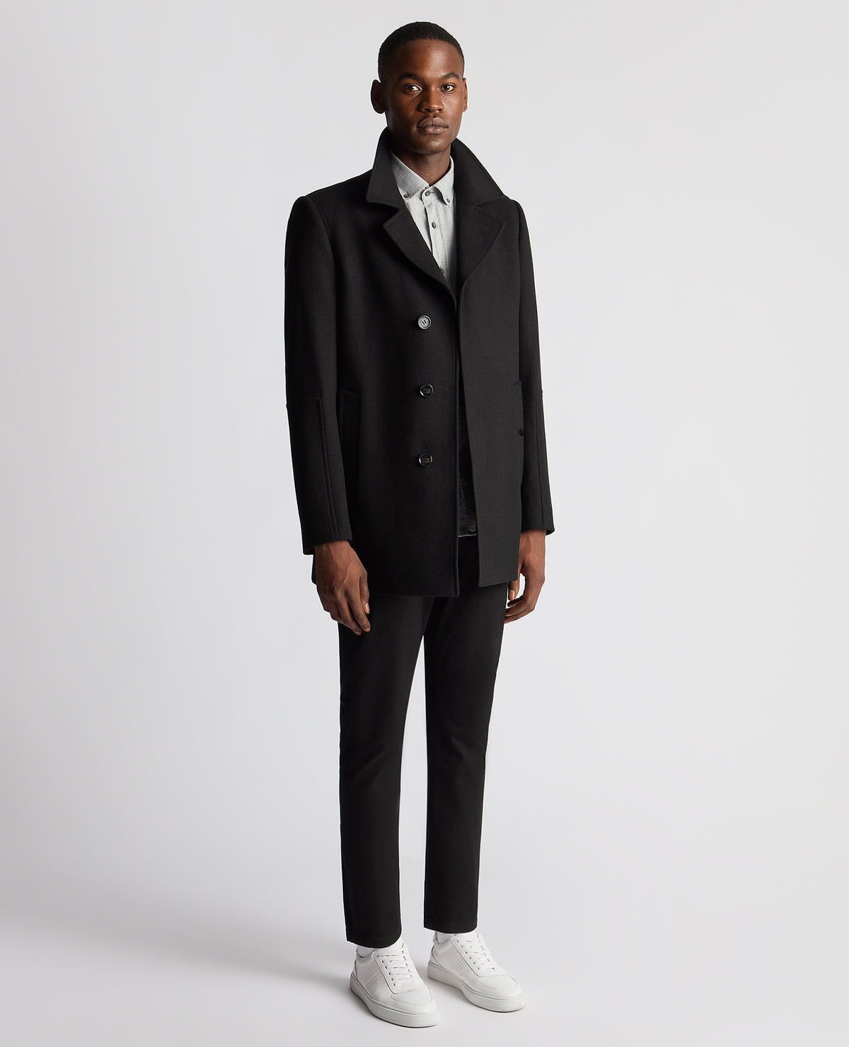 Man wearing a black Tailored Fit Overcoat