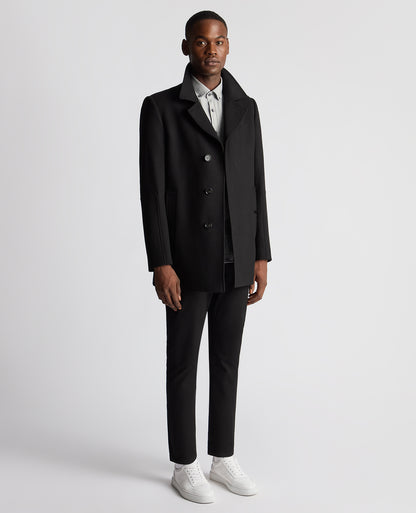 Man wearing a black Tailored Fit Overcoat
