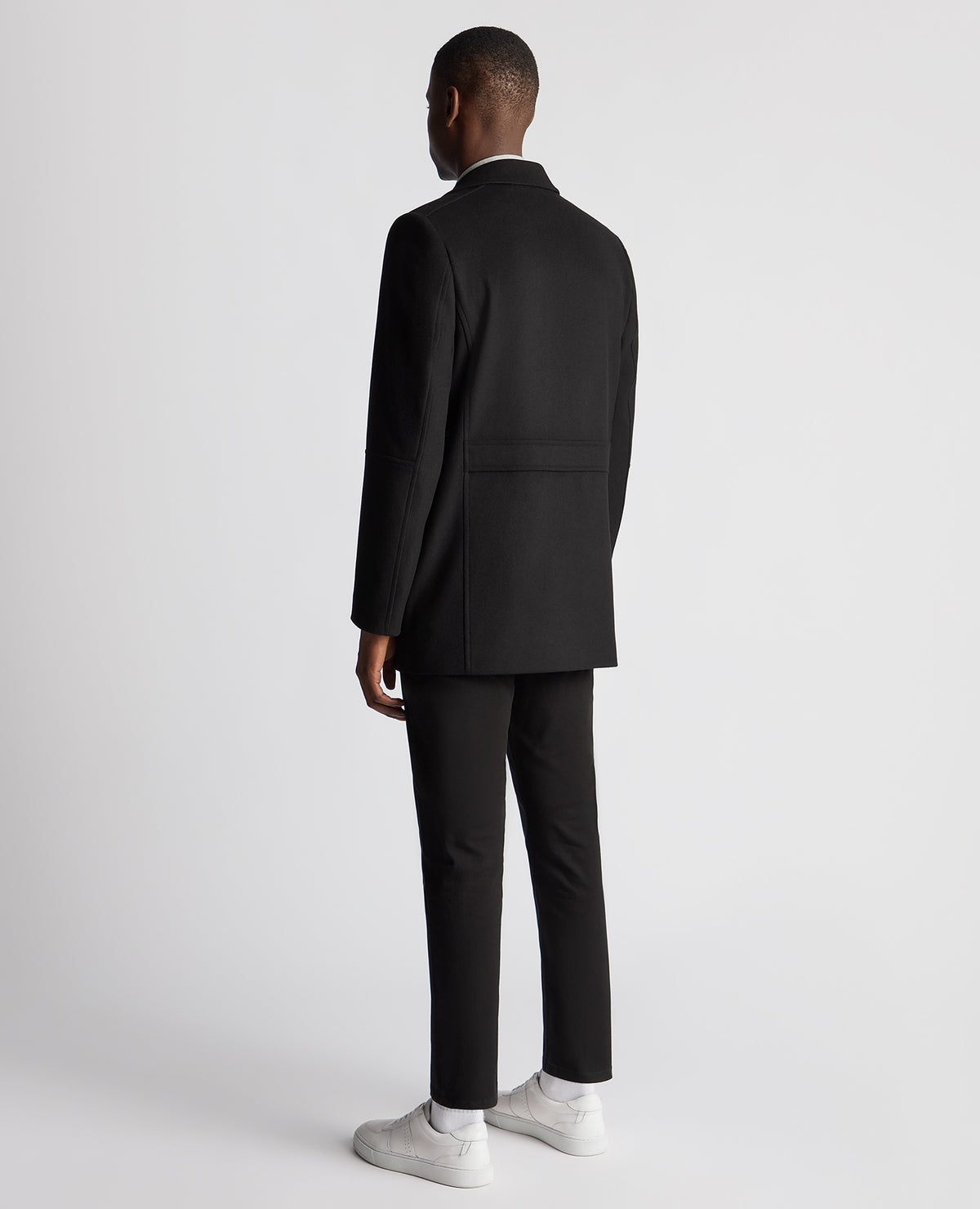 Man wearing a black Tailored Fit Overcoat