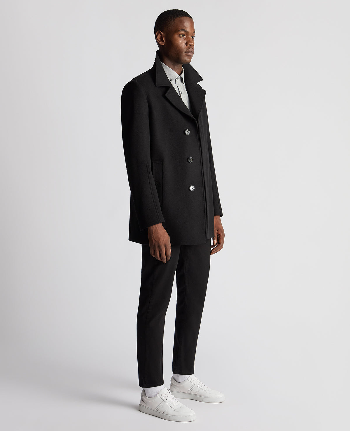 Man wearing a black Tailored Fit Overcoat