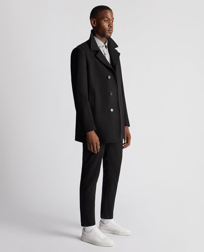 Man wearing a black Tailored Fit Overcoat