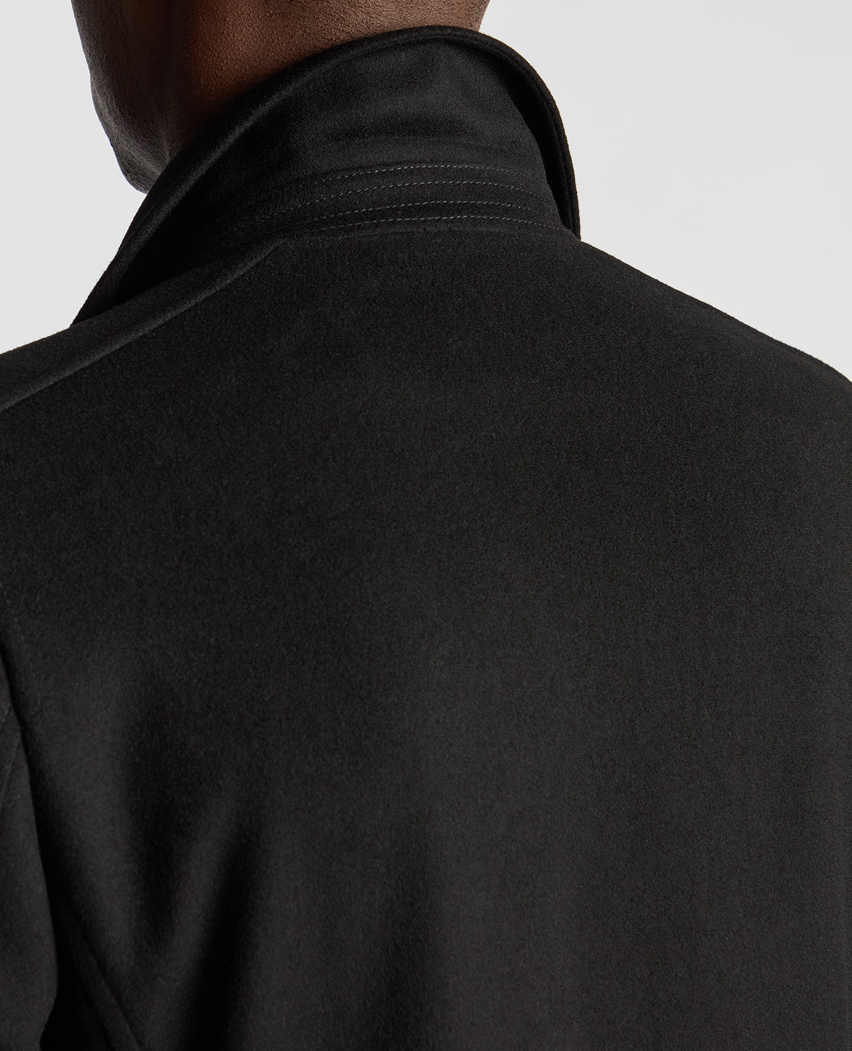 Man wearing a black Tailored Fit Overcoat