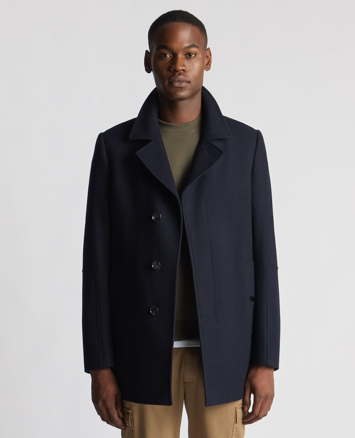 Man wearing a navy Tailored Fit Overcoat