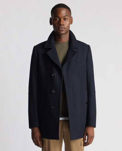 Man wearing a navy Tailored Fit Overcoat