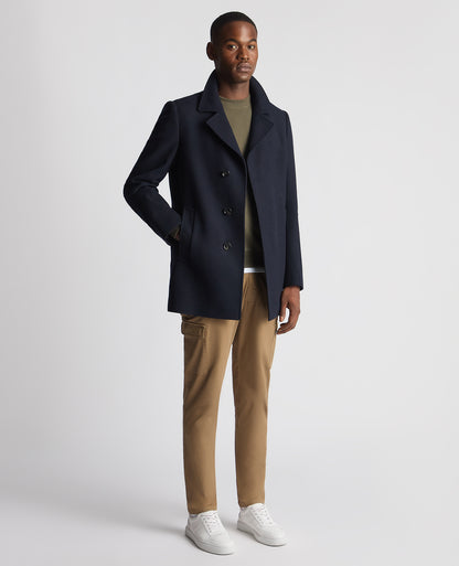 Man wearing a navy Tailored Fit Overcoat