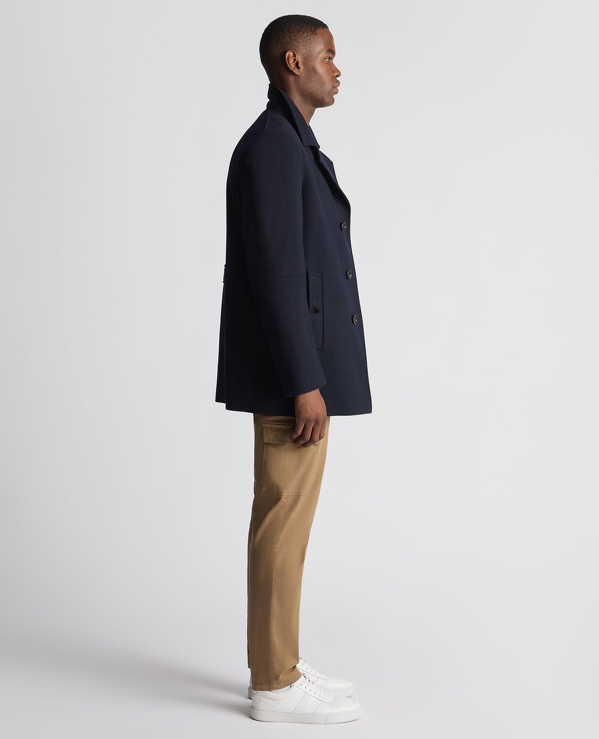 Man wearing a navy Tailored Fit Overcoat