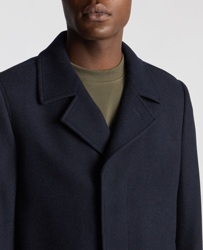 Man wearing a navy Tailored Fit Overcoat