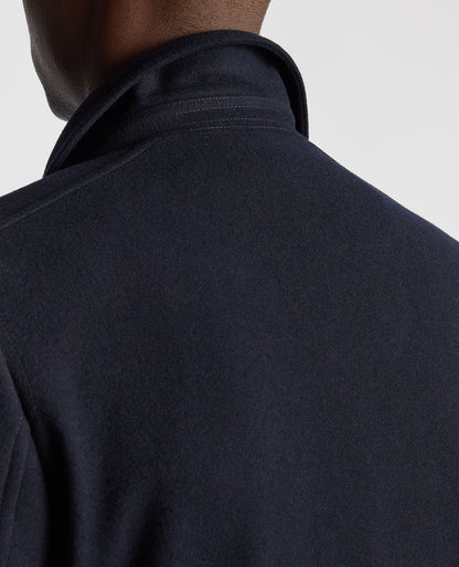 Man wearing a navy Tailored Fit Overcoat