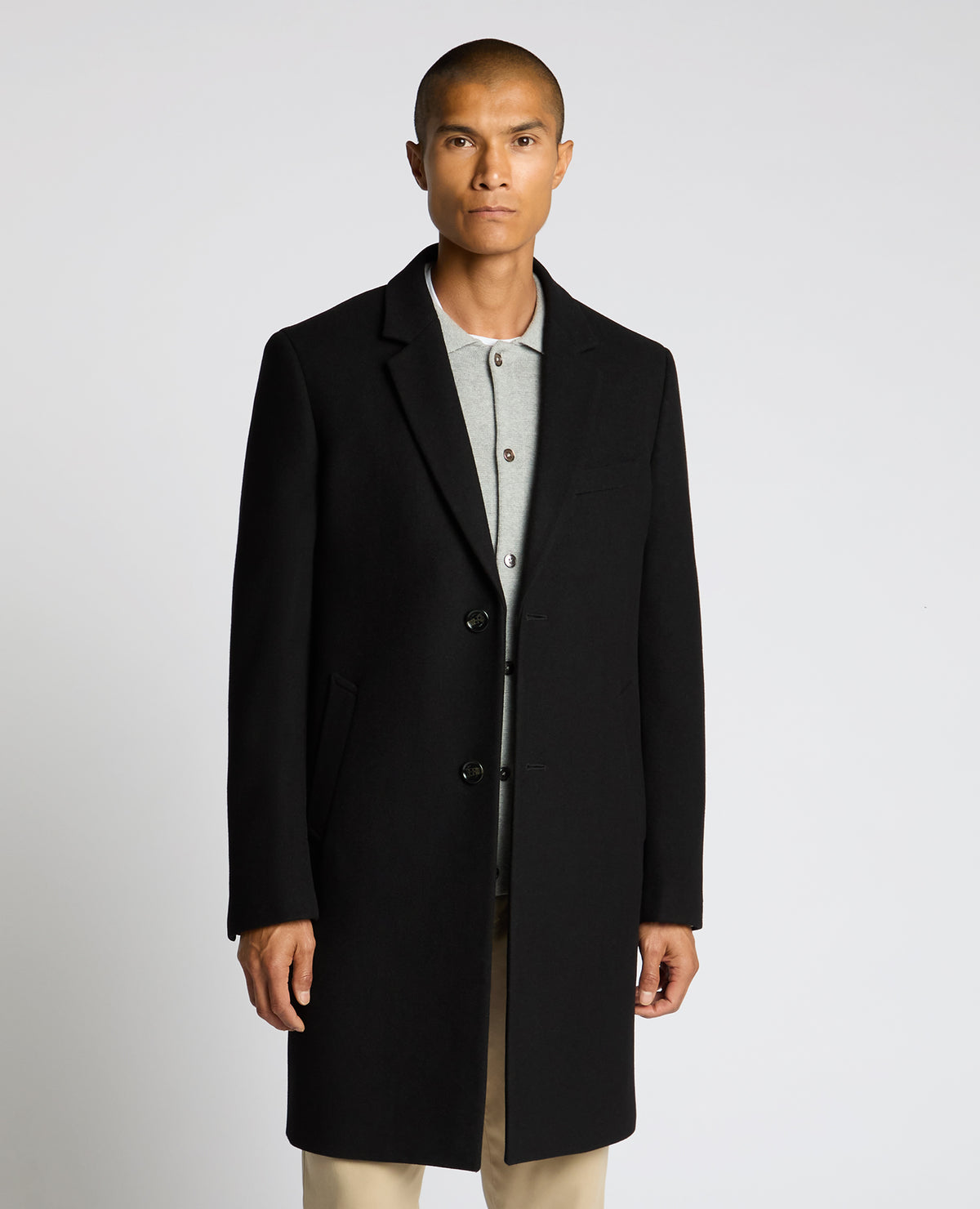 Man wearing a black Kayden Tailored Fit Chelsea Overcoat