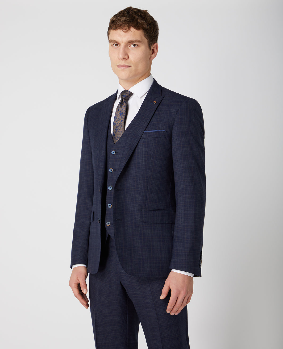 Man wearing a navy Tapered Fit Checked Wool Rich Mix and Match Suit