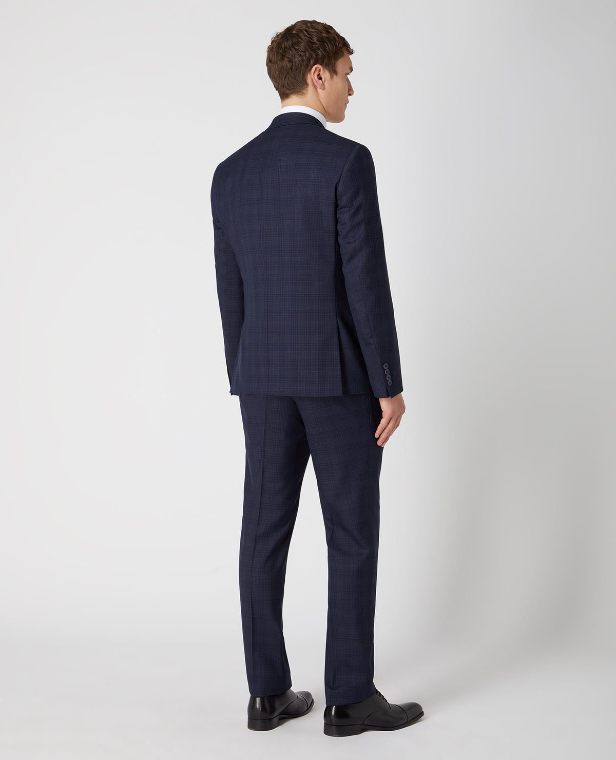 Man wearing a navy Tapered Fit Checked Wool Rich Mix and Match Suit