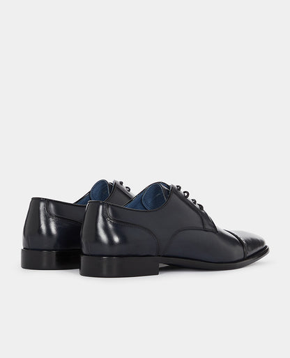 Man wearing a navy Leather Bonucci Shoe