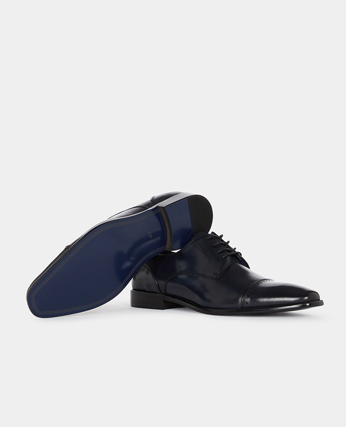 Man wearing a navy Leather Bonucci Shoe