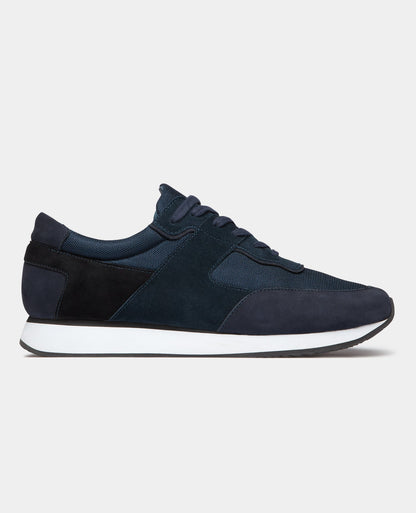 Man wearing a navy Suede Trainer