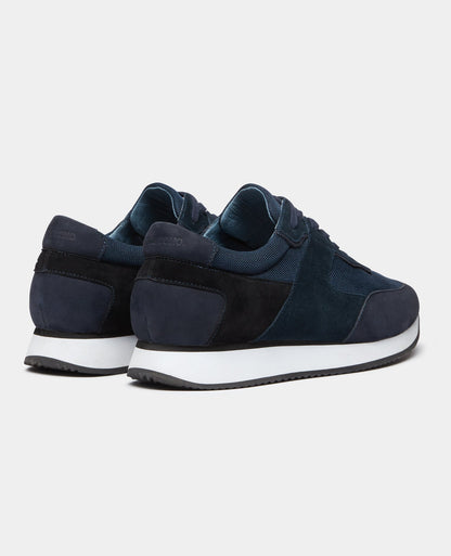 Man wearing a navy Suede Trainer