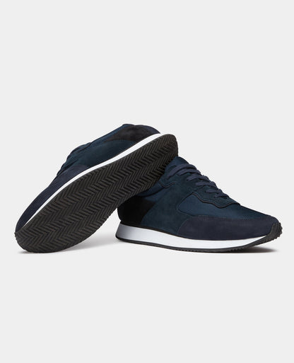 Man wearing a navy Suede Trainer