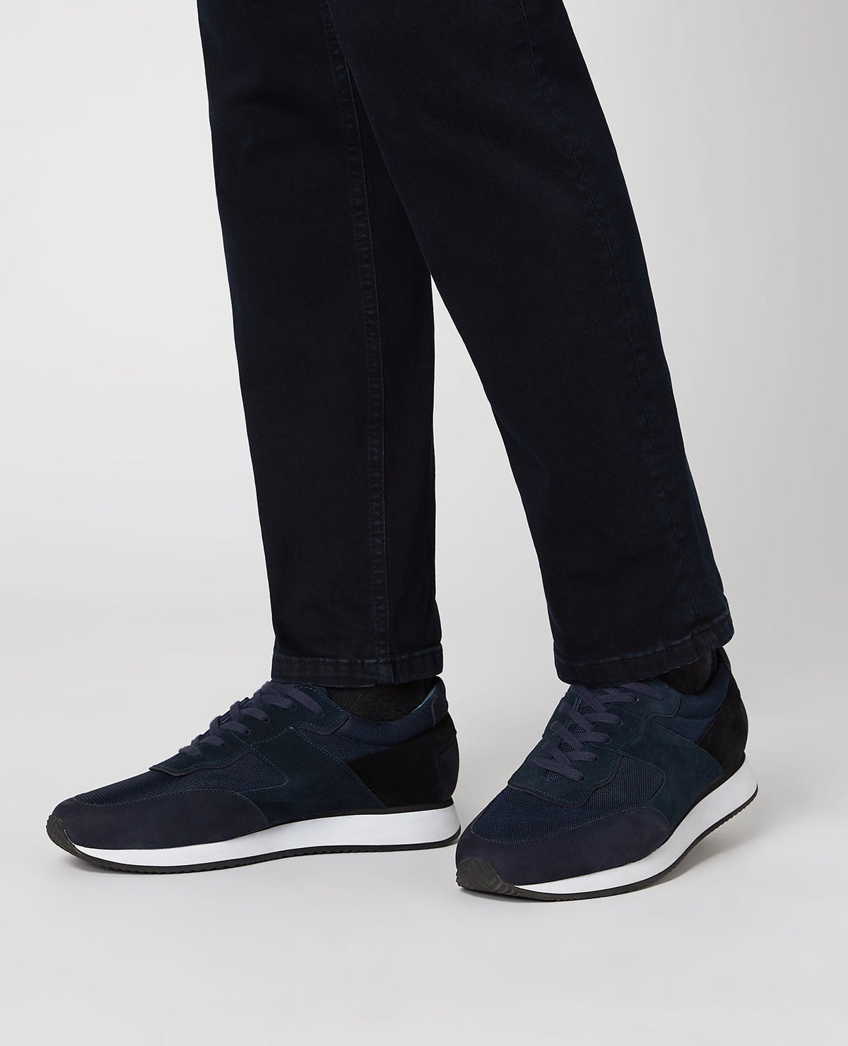 Man wearing a navy Suede Trainer