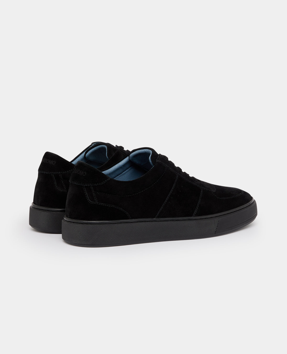 Man wearing a black Suede Enrico Trainer