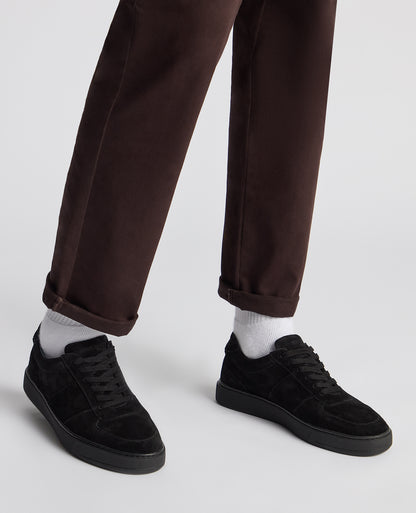 Man wearing a black Suede Enrico Trainer