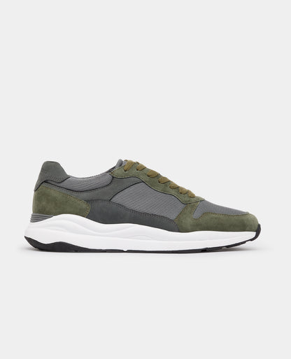 Man wearing a green Suede Albi Trainer