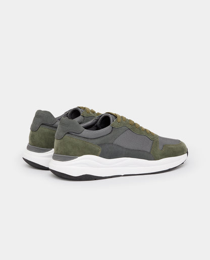 Man wearing a green Suede Albi Trainer