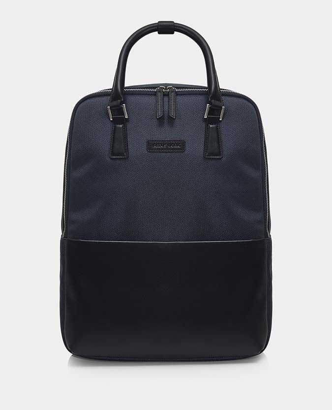 Man wearing a blue Leather-Trimmed Backpack