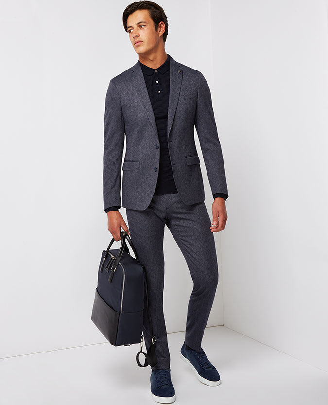 Man wearing a blue Leather-Trimmed Backpack