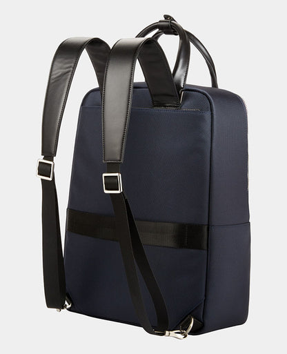 Man wearing a blue Leather-Trimmed Backpack
