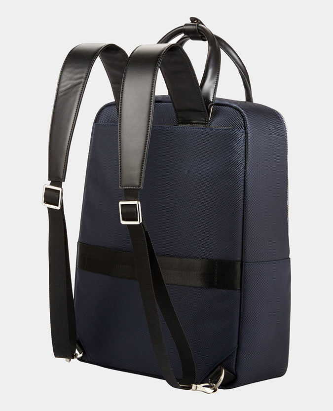 Man wearing a blue Leather-Trimmed Backpack