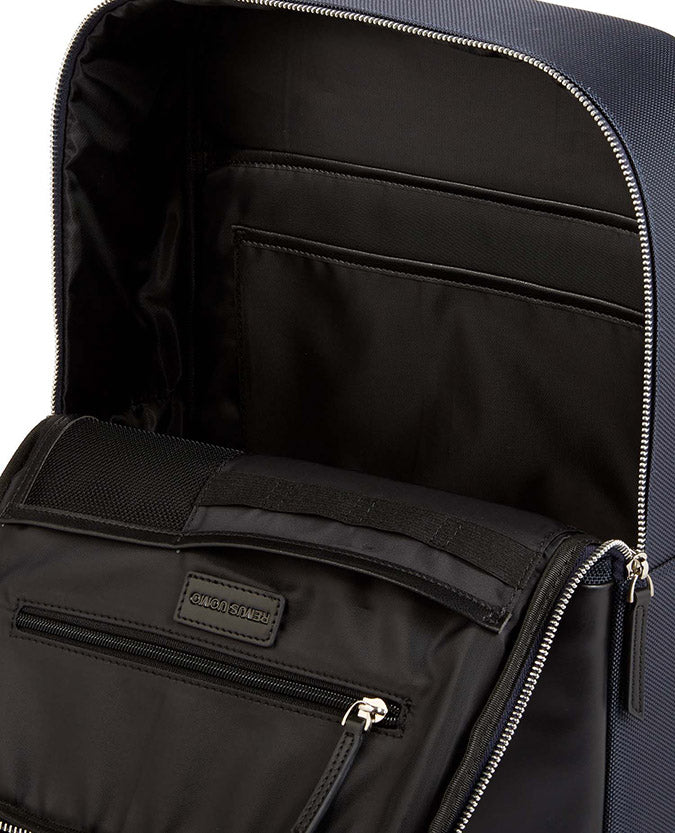 Man wearing a blue Leather-Trimmed Backpack