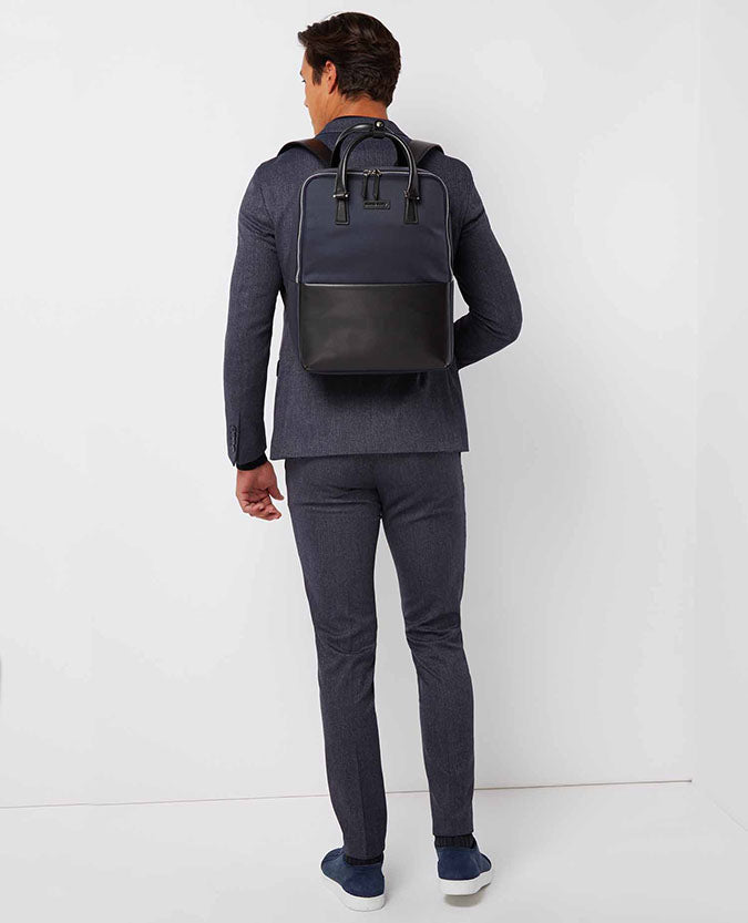 Man wearing a blue Leather-Trimmed Backpack